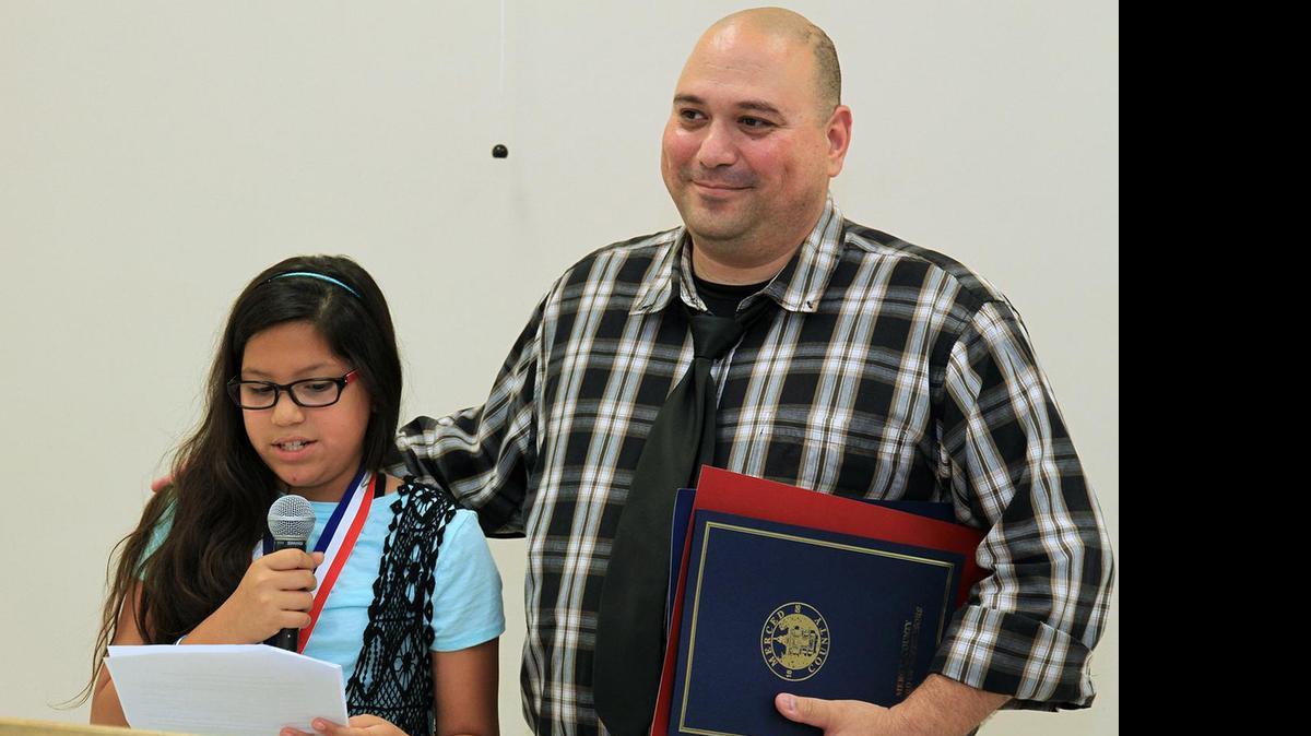 
Nelson Ortiz, 43, listens to his daughter, Eliana, speak during the Merced County Father of the Year Essay Awards Banquet on Tuesday in Merced. Ortiz took home the top honors.
