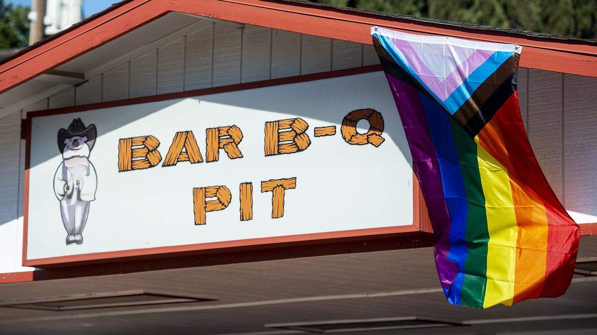 A Pride flag is displayed on the exterior of the Bar B-Q Pit restaurant in Merced, Calif., on Thursday, June 10, 2021. Earlier in the week, an employee found a Pride flag that had previously displayed on the building burned, according to owner Roy Mercado.