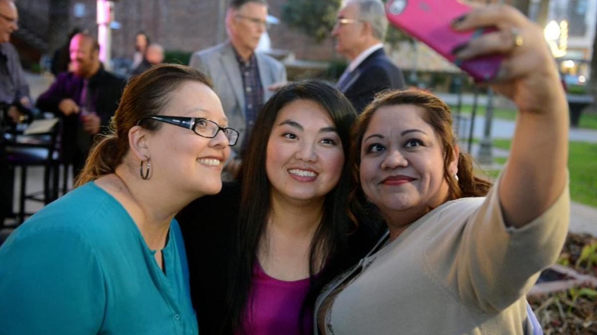 Merced County Board of Supervisors candidate Lee Lor, center, poses for a selfie with supporters Monica Sevilla, left, and Maria Ilse Cuevas at Lor’s campaign kickoff on Wednesday, Feb. 10, 2016, in downtown Merced. She will face incumbent Supervisor Hub Walsh.
