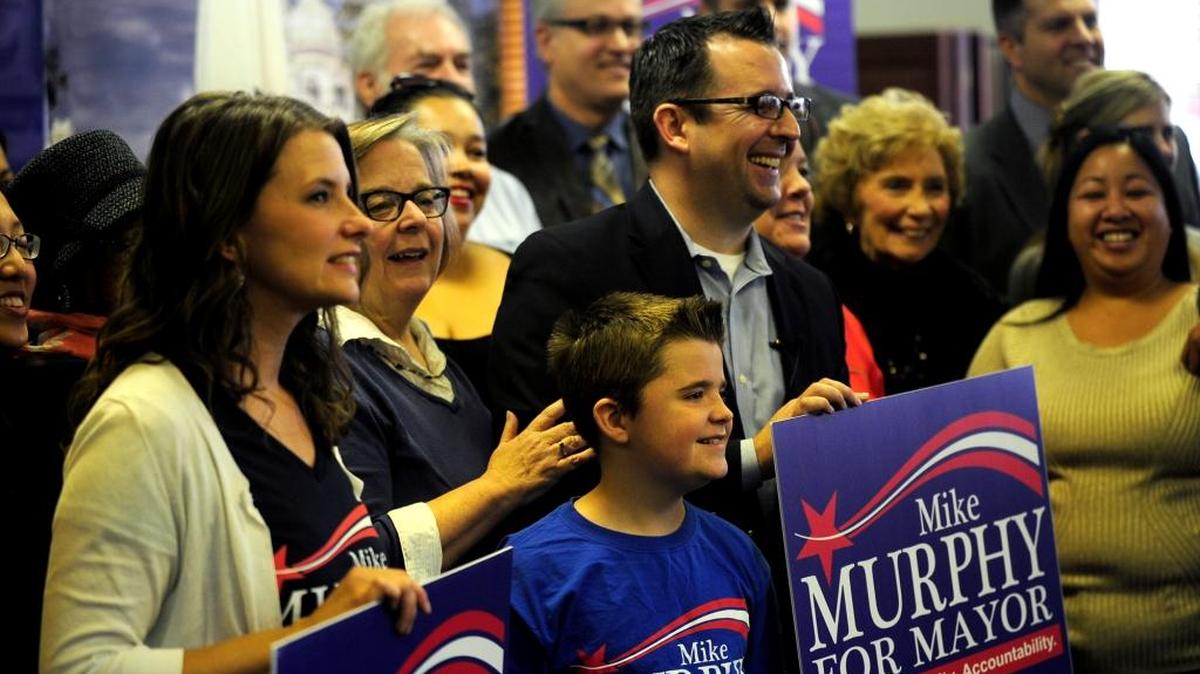 Mike Murphy, center, stands with his family and supporters as he announces his run for mayor of Merced on Thursday, Dec. 3, 2015.