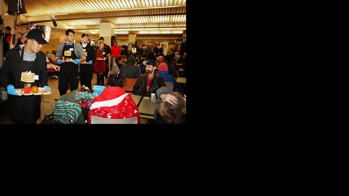 Maryland players serve people at St. Anthony’s Dining Room in San Francisco on Sunday. Maryland will face Stanford in the Foster Farms Bowl on Tuesday.<252>