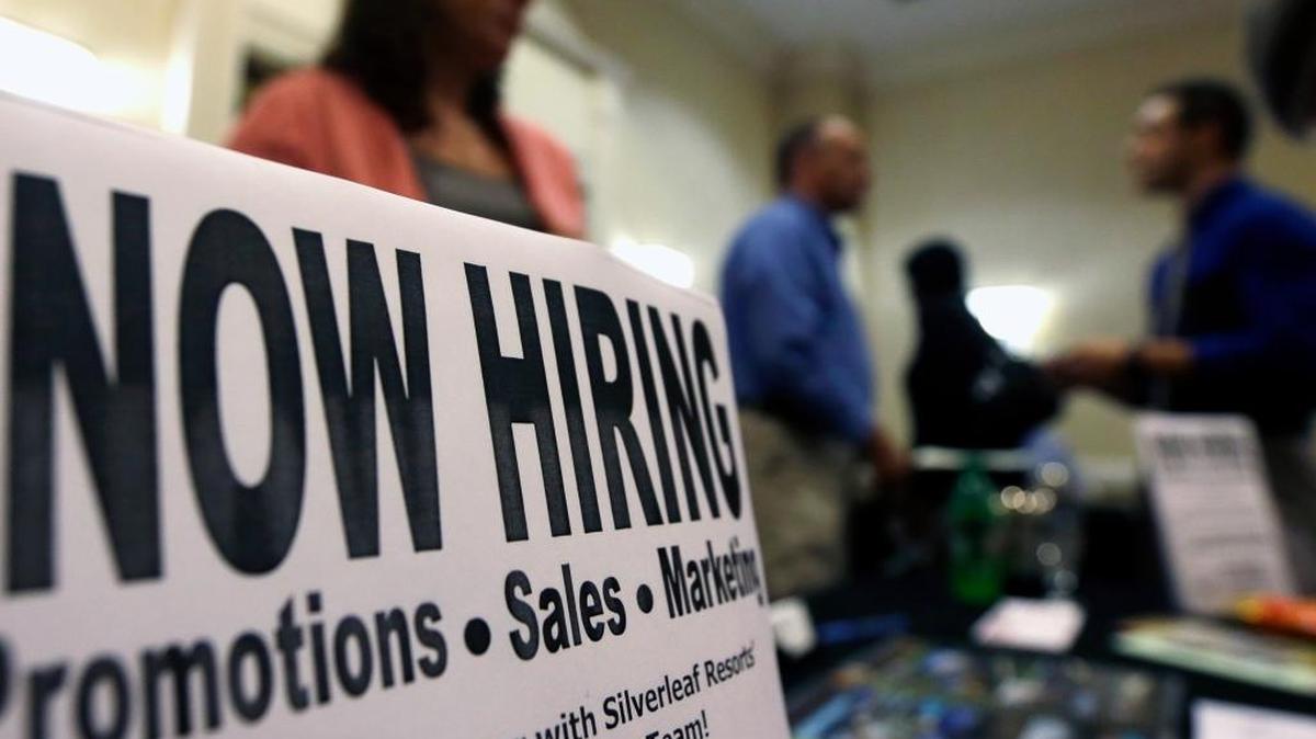 A sign attracts job-seekers during a job fair at the Marriott Hotel in Colonie, N.Y., in 2012. Unemployment figures were down slightly in January, compared with January 2015, while labor force numbers remained steady, labor market analysts said Friday.