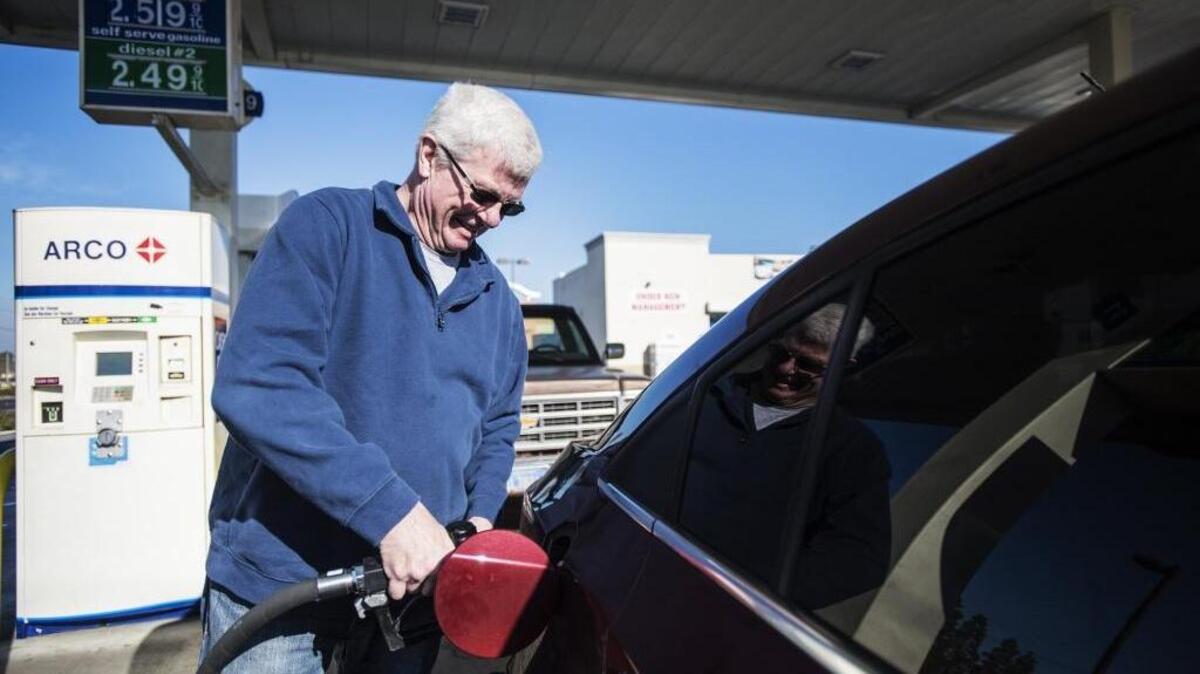 Keith Wilson, 70, of Merced, fills up his tank Wednesday at the Arco gas station at 3100 G St. in Merced. Wilson says a recent road trip sharpened his awareness of gas pricing.