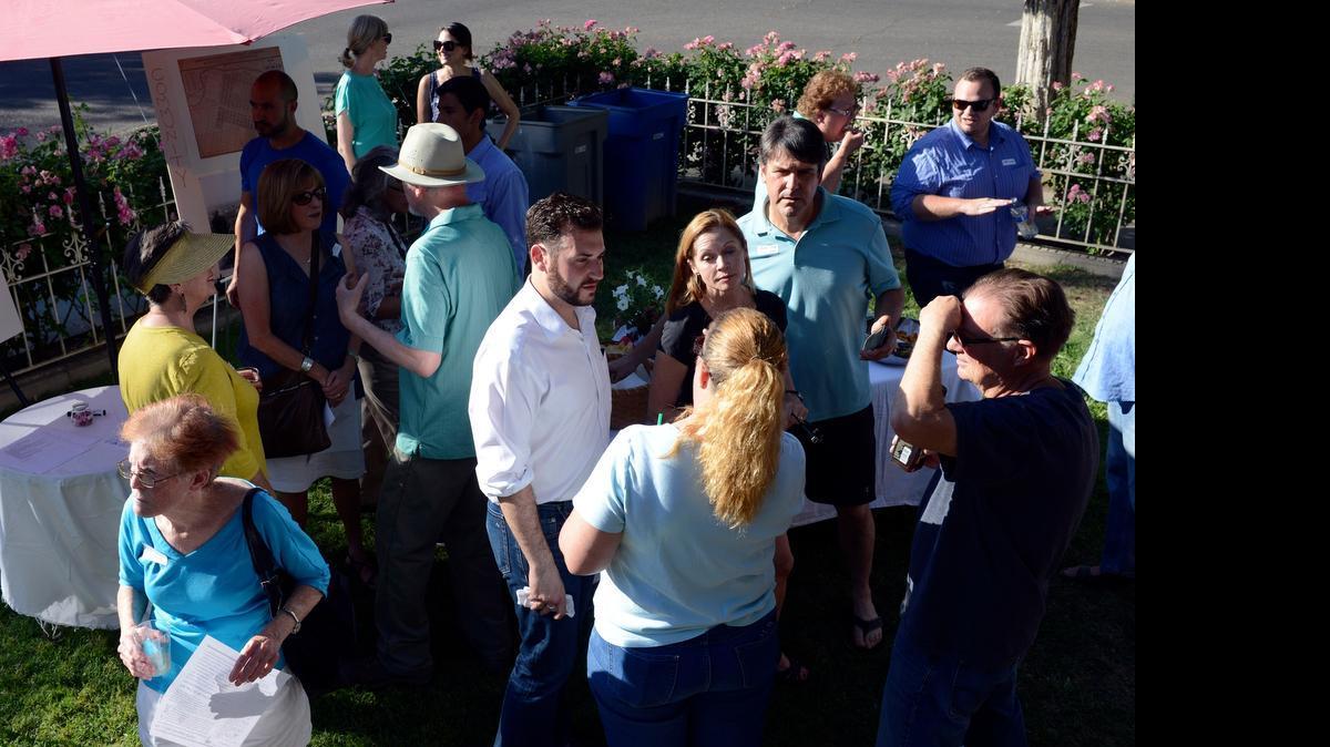 
Residents of Merced’s downtown mingle during the first gathering of the Downtown Neighborhood Association, or DNA, on Friday. The group looks to revitalize Merced’s historic city blocks.
