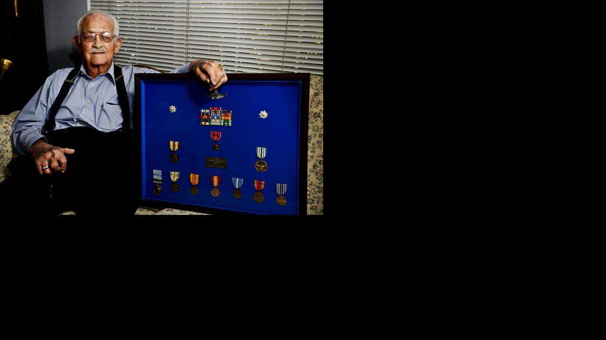 
Veteran Robert Gilbert, 92, who served in World War II, the Korean War and the Vietnam War, poses with medals at his Merced home.
