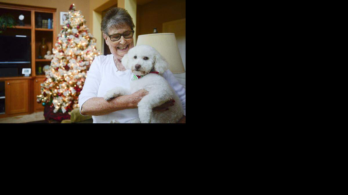 
Jani Clarke, 77, of Merced excitedly holds her poodle, Toby, at her home with husband Jack in Merced on Friday. The Clarkes’ home is one of the stops along the Merced Society for the Prevention of Cruelty to Animals Christmas Home Tour. 

