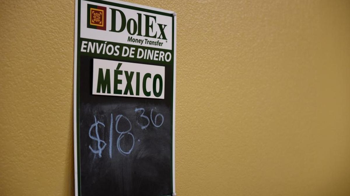 A sign at Iberoamericana Travel in Merced shows the peso-to-dollar exchange rate. The depreciation of the peso is driving people who send money to their families in Mexico to send larger amounts or more often, shop owners say.