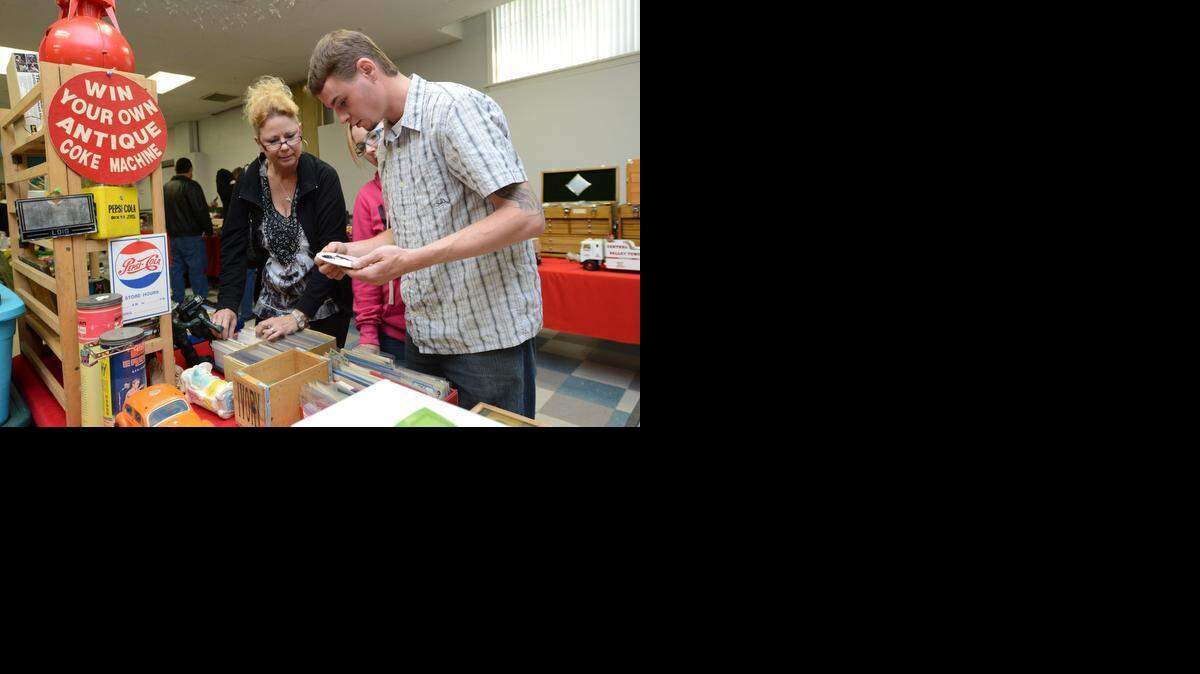 
Cary Cooke of Fresno, right, looks at Batman pins with Amber Hall-Holmes of Fresno and Lori Sandelin of Clovis during the 2013 show.
