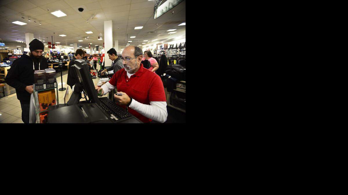 
David Gutierrez, 63, of Atwater, helps a customer at JCPenney in the Merced Mall on Friday. According to Gutierrez, the store opened at 6 a.m. to accommodate shoppers. The day after Christmas is the second-busiest shopping day of the year.
