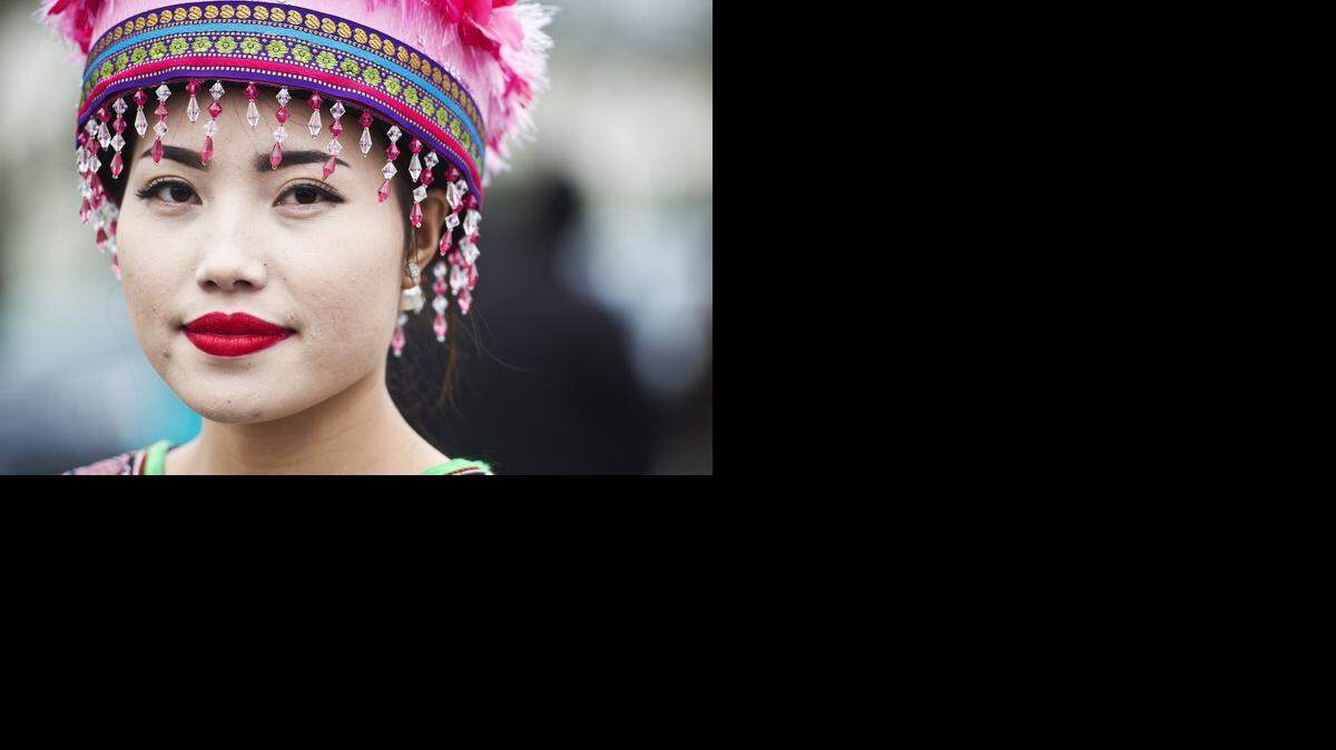 
Maila Yang, 20, of Fresno, surveys the crowd while waiting for festivities to begin during the Hmong New Year celebration at the Merced County Fairgrounds in Merced on Friday. The celebration, which includes traditional clothing and dancing, will continue through Sunday afternoon.
