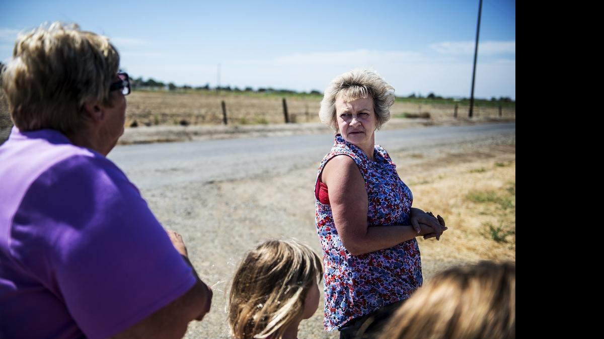 
Allyne Beutel, right, turns to speak with Kathy Silva, left, while discussing Wednesday the proposed path of new transmission poles and power lines to be placed by the Merced Irrigation District. Residents are concerned about the possible health effects of the power lines being located so close to their homes as well as a decrease in property value.
