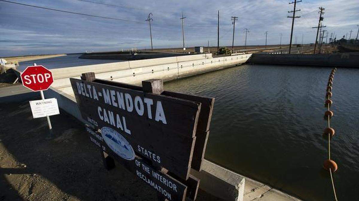 Water runs through the Delta-Mendota Canal in Merced County, where a proposed farmland sale to Silicon Valley’s water agency is generating controversy.