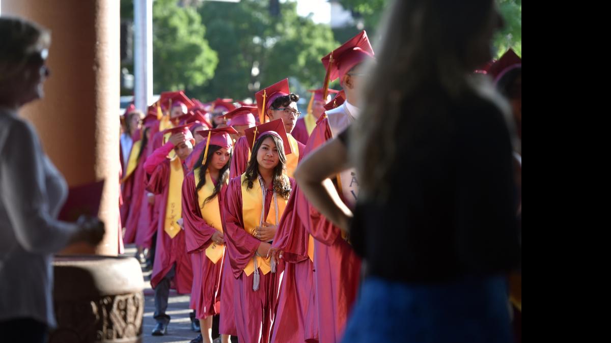 
Graduating seniors at Golden Valley High School in Merced line up on Child Avenue as they prepare to enter the school for their graduation ceremony on Thursday.
