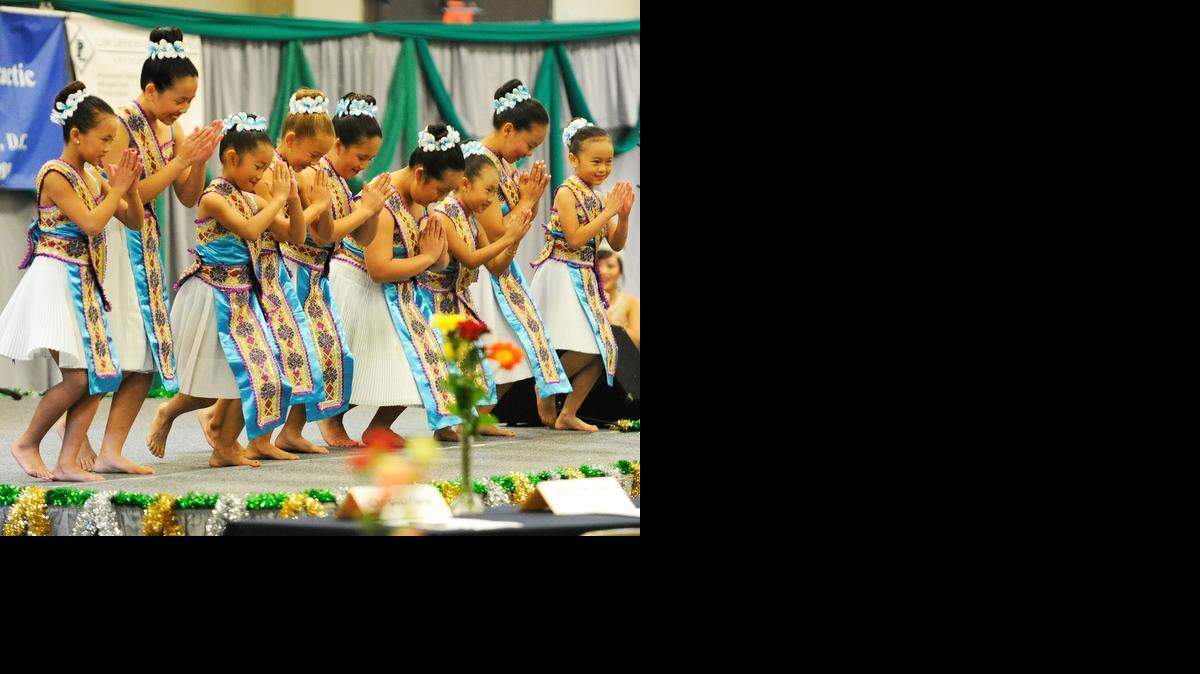 
Members of a youth dance group bow as they finish their performance to open the beauty pageant at last year’s Hmong New Year at the Merced County Fairgrounds.
