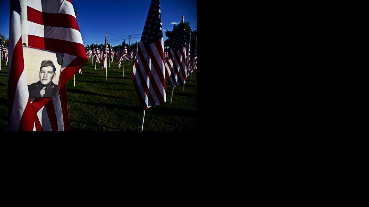 
A photograph of U.S. Army veteran Joe Salvador Lara is attached to a flag placed in his honor during the second annual Field of Honor on the Merced College front lawn in Merced on Sunday, Nov. 2. The Field of Honor recognizes veterans, first responders and active duty military members. The flags will remain on the college lawn until Nov. 11.
