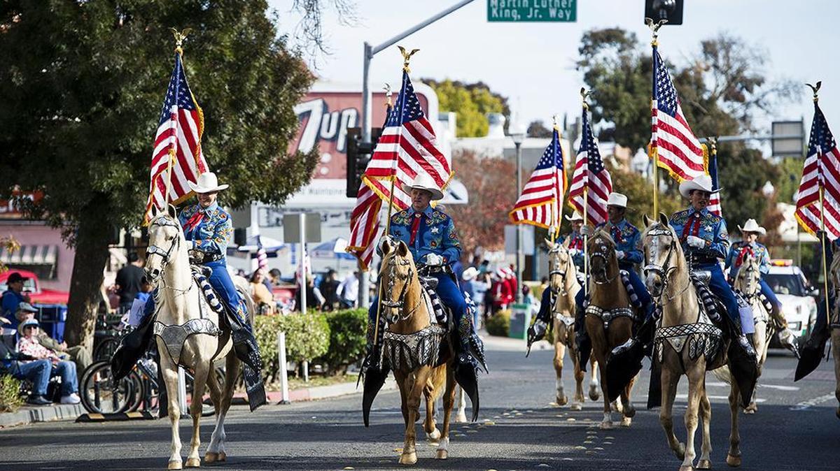The Merced County Sheriff’s Posse rides down Main Street during the Merced Veterans Day Parade in Merced, Calif., on Saturday, Nov. 11, 2017.