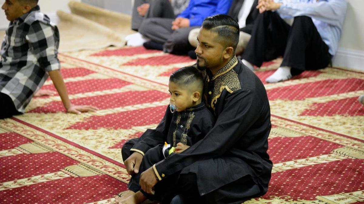 
Tahir Bath, 40, holds his 1-year-old son, Zayaan, during the prayer for the Muslim holiday Eid al-Adha at the Islamic Center of Merced on Thursday, Sept. 24, 2015.
