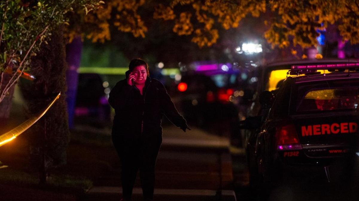 A woman becomes emotional while speaking on her phone as the Merced Police Department investigates the scene of a homicide outside an apartment complex in the 3300 block of San Mateo Court in Merced, Calif., on Friday, April 28, 2017. According to Detective-Sgt. Curt Gorman, a Hispanic male is dead after suffering multiple gunshot wounds following a verbal argument with three men outside the apartment complex. According to Merced Police no arrests have been made.