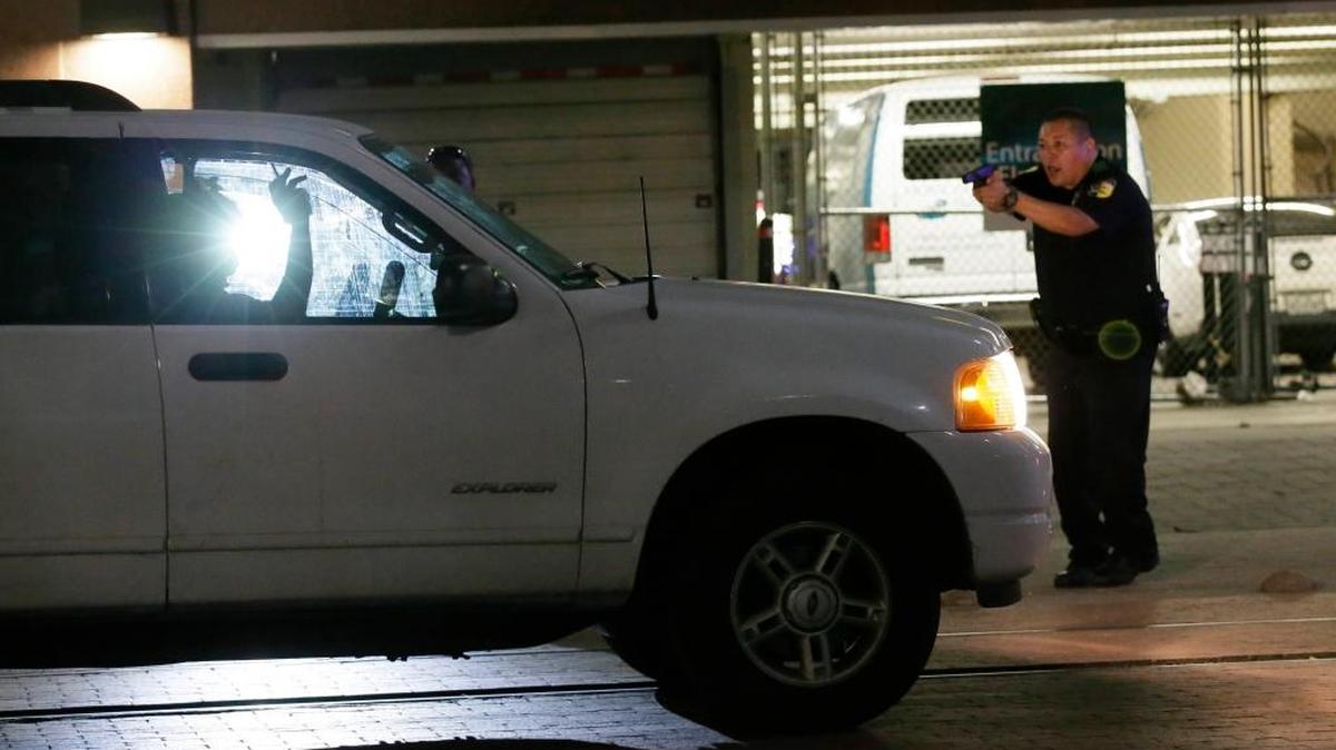 A police officer stops a driver in downtown Dallas on Thursday, July 7, 2016, after police officers were shot and killed during a protest over fatal police shootings of black men in other states.