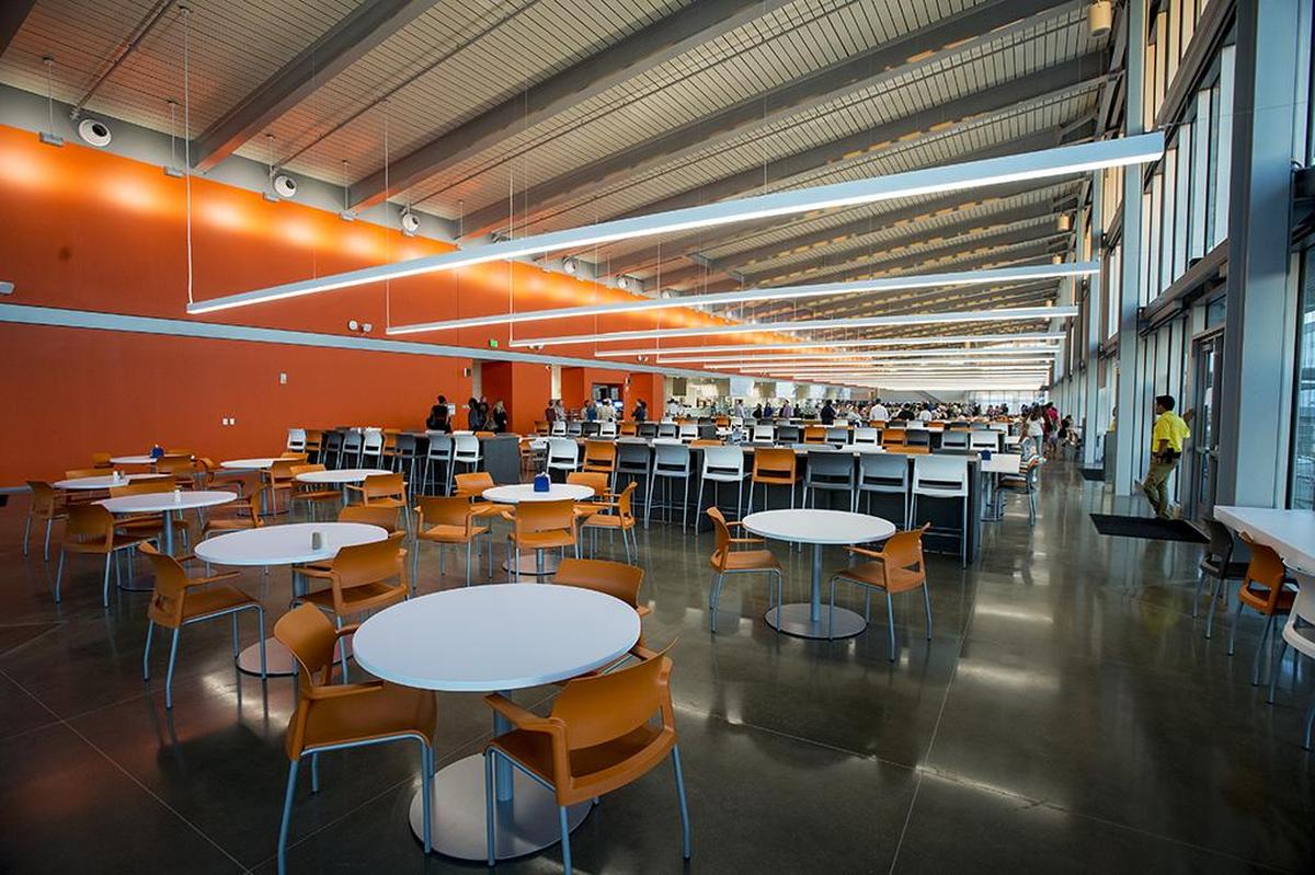 Guests walk through The Pavilion, a new dining facility before a building lighting ceremony to celebrate the opening of the first three buildings of the Merced 2020 Project, on the UC Merced campus in Merced, Calif., on Thursday, Aug. 16, 2018.