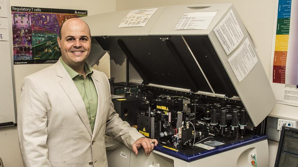 UC Merced Assistant Project Scientist David Gravano stands next to his flow cytometer machine in his office Monday, September 10, 2018. He is recognized as one of the Merced Sun Star’s 20 Under 40 class of 2018.