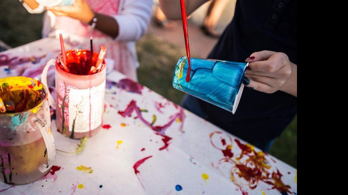 
Kacey Herman, 9, of Merced paints a garden cup during the Merced Art Hop on Saturday.

