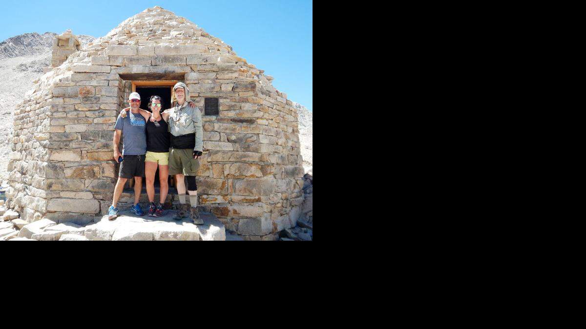 
Richard Rasmussen, left, Valerie Marquis of Seattle and Richard’s cousin, Eric Rasmussen, pause for a moment at the Muir Hut. 
