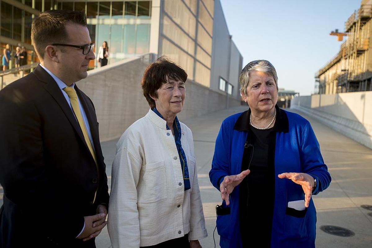 University of California President Janet Napolitano, right, speaks to media with UC Merced Chancellor Dorothy Leland, center, and Merced Mayor Mike Murphy, left, before a building lighting ceremony to celebrate the opening of the first three buildings of the Merced 2020 Project, on the UC Merced campus in Merced, Calif., on Thursday, Aug. 16, 2018.