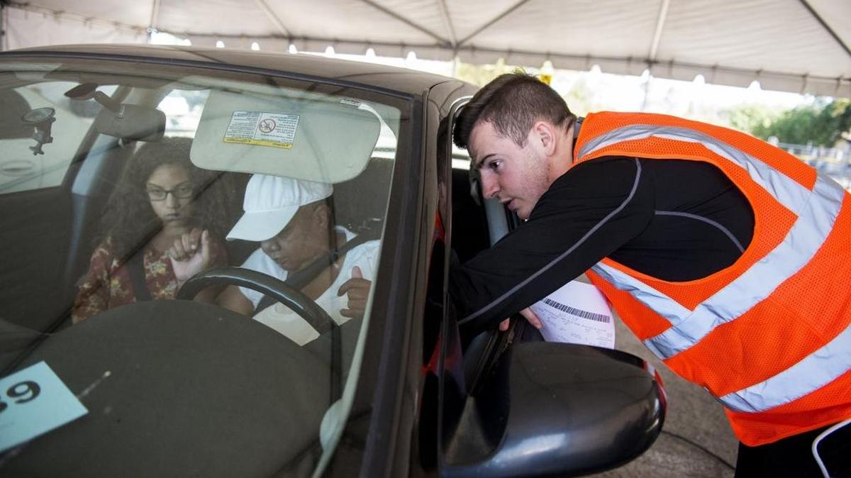 Matt Dull, 23, of Santa Cruz assists motorist Vernelle McMurray, 60, of Merced in checking the emissions of her car during the Valley Clean Air Now’s Tune In and Tune Up event held at the Merced County Fairgrounds in Merced, Calif., on Saturday, Sept. 24, 2016. The event, sponsored by the San Joaquin Valley Air Pollution Control District, aims to reduce vehicle pollutants by offering free smog testing. According to Valley CAN, if a vehicle is deemed a high polluter, Valley CAN will issue a $500 voucher for emission-related repairs at local certified smog shops.
