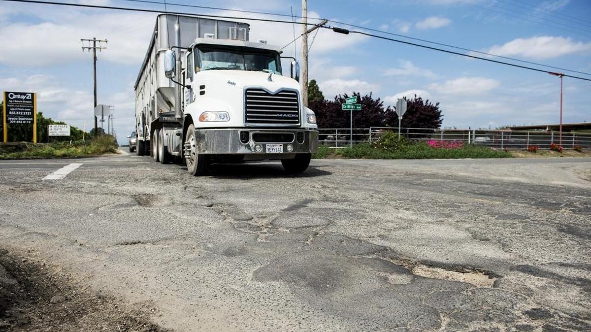 Potholes mar the pavement where Griffith Avenue and Bradbury Road meet in Delhi, Calif., on Tuesday, April 12, 2016. The Merced County Board of Supervisors has rejected claims from motorists who blame potholes on county roads for damage to their vehicles.