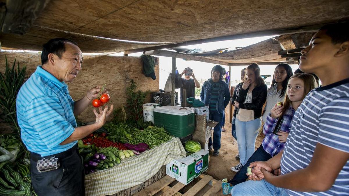 Cha Teng Herr, owner of Herr Farm, left, speaks to Snelling Elementary School students during a Farm to School event at Herr Farm in Atwater, Calif., Wednesday, Sept. 21, 2016. Students learned about farming and healthy eating during the event organized by United Way of Merced County and the Merced County Department of Public Health.