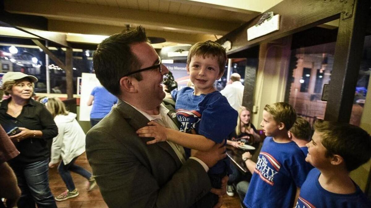 Merced mayoral candidate Mike Murphy lifts his son Nash, 4, as he celebrates his lead over fellow mayoral candidates at Pinocchio's Restaurant in Merced, Calif., Tuesday, Nov. 8, 2016.