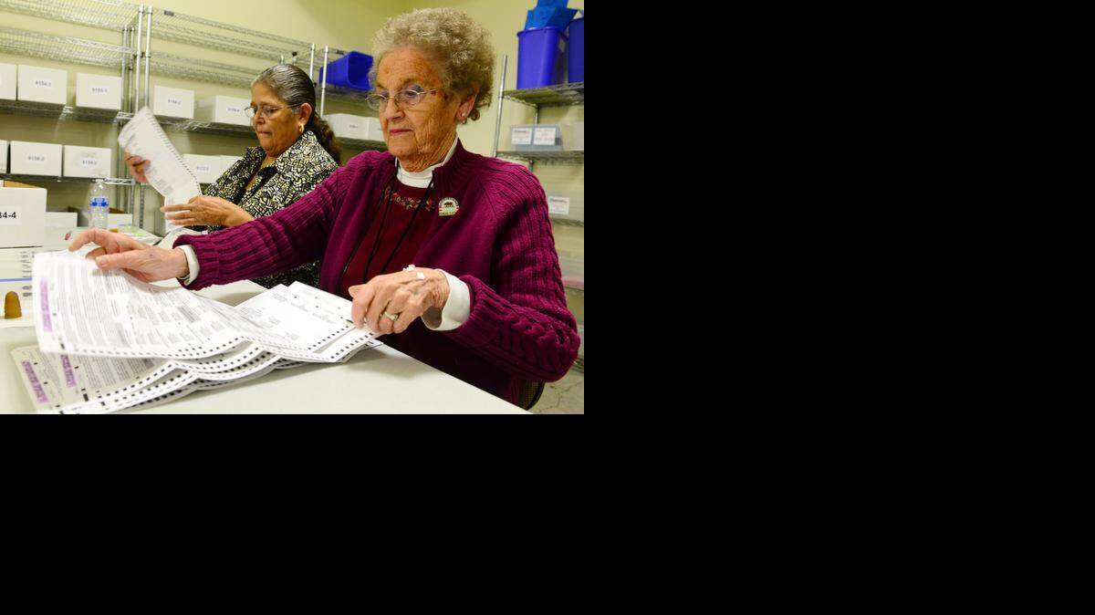 
Seasonal Merced County elections employees Gloria Garcia, left, and Betty Hale go through absentee ballots on Monday, November 3, 2014, in the county’s Registrar of Voters warehouse in Merced.
