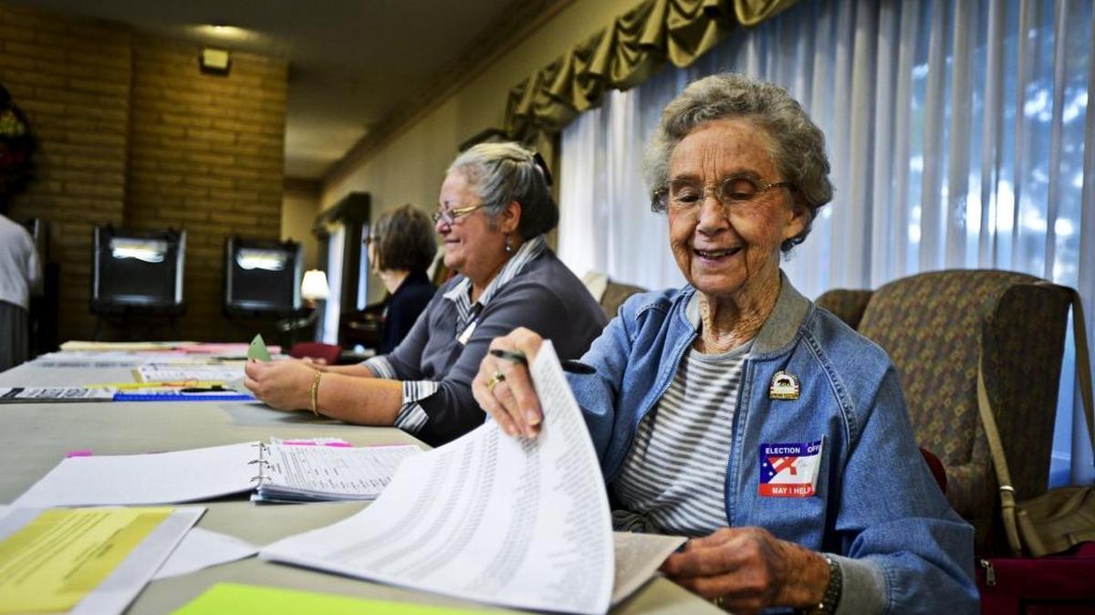 Election Day volunteer Marilyn Reese, 88, looks through a list of registered voters in Merced, Calif., in November 2014. For the June 2016 election in Merced County, the registrar’s office is preparing for a relatively high turnout, with plans for extra staffing and booths in high-traffic areas.