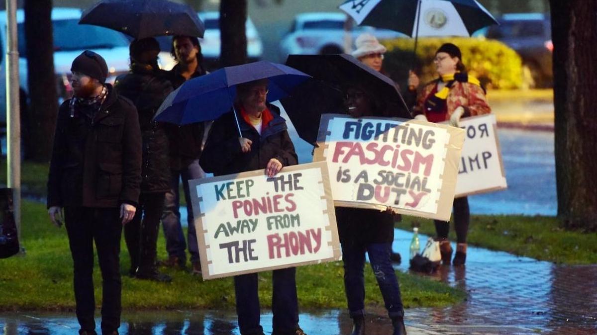 Protesters gather outside the Elks Lodge on Sunday to denounce the Merced County Sheriff’s Posse’s planned trip to the presidential inauguration of Donald Trump.