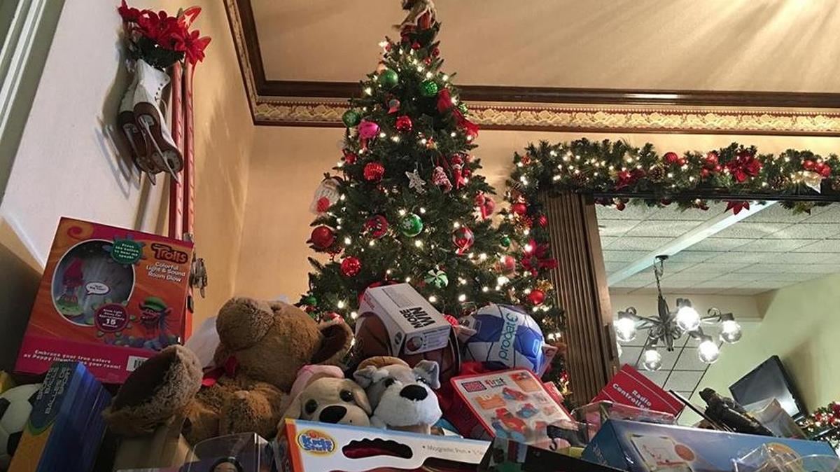 A pile of toys donated by the community under a Christmas tree at the Merced Golf and Country Club on Thursday. The toys are for the annual Firemen and Cops for Kids toy drive organized by the Merced Police Department and Merced City Fire Department. Toys will be given out to children under age 13 in the community.