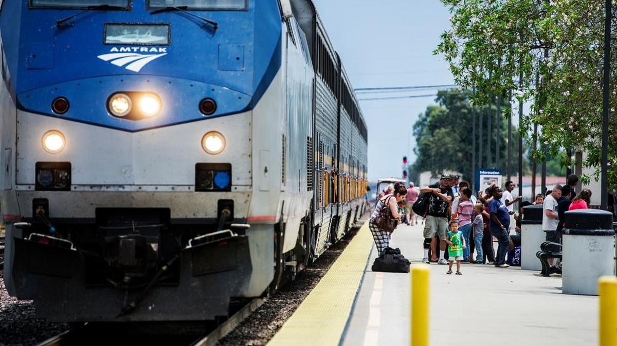 
Passengers load onto an Amtrak train at the Merced Amtrak Train Station in July. 
