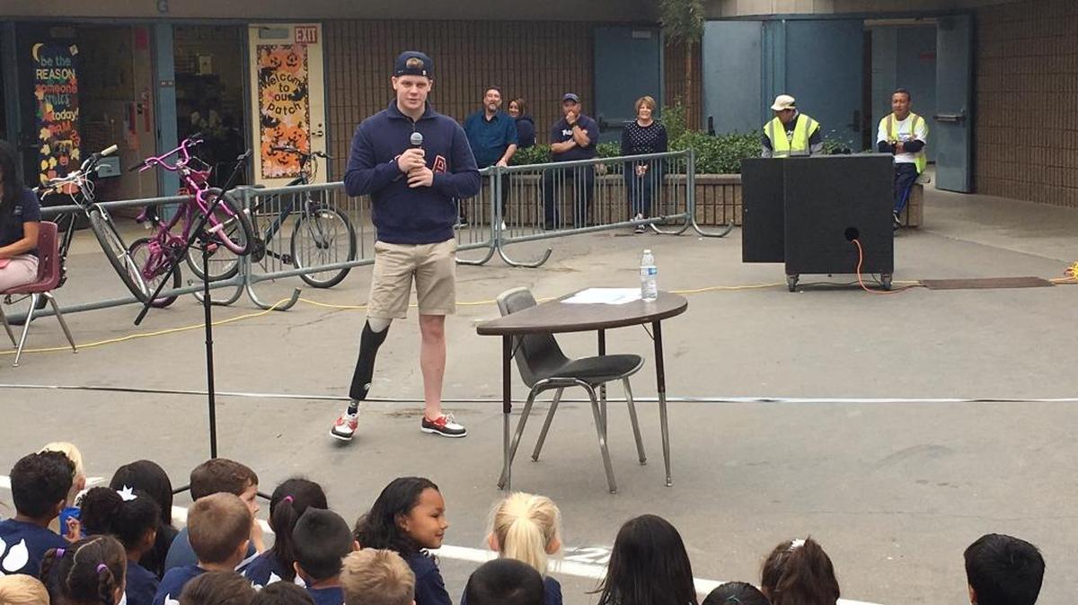 Tye Dutcher, a member of Team USA’s paralympic swimming team, talks to students on Friday, Oct. 14, 2016, at Peterson Elementary School.