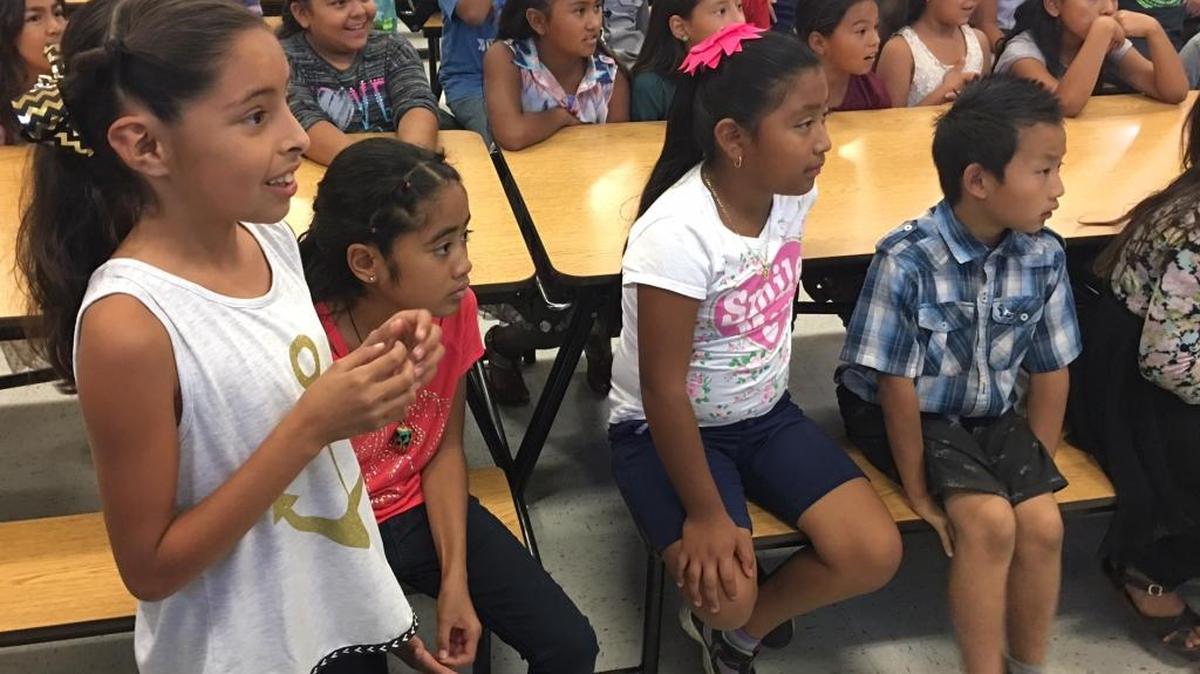 Sheehy Elementary fourth-grader Hennessy Sotelo asks the Merced College football captains a question Friday, Sept.30, 2016.