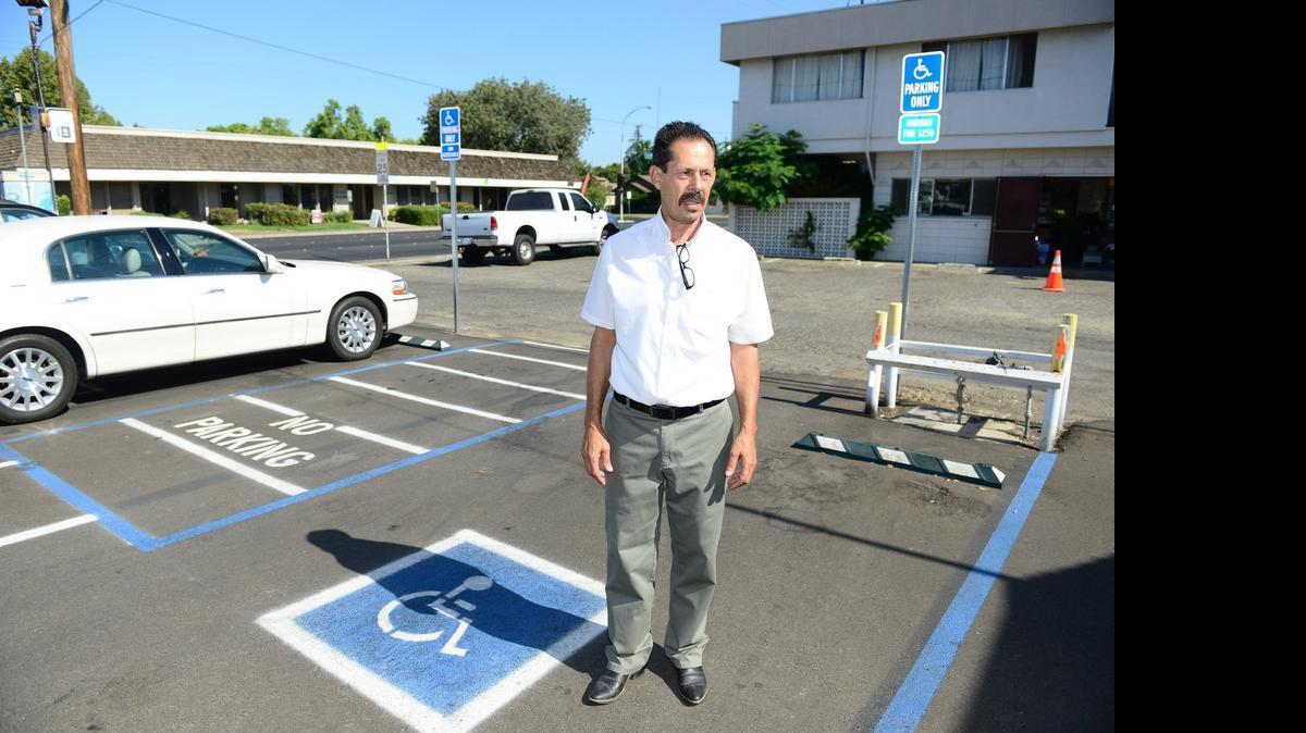 
The owner of The Barbecue Pit, Roy Mercado, stands in front of his restaurant in August and explains changes he made to his parking lot after being hit with an ADA lawsuit. Senate Bill 251 gives businesses 30 days to fix violations.
