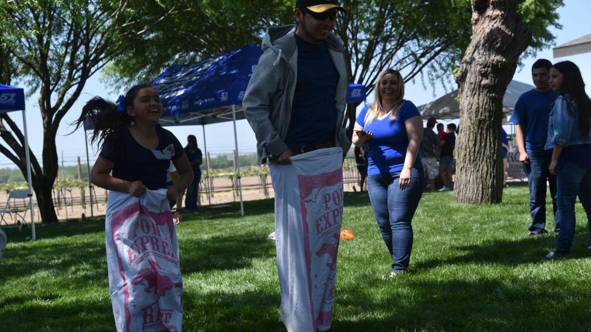 Two people in a potato sack race during Families With Autism on Sunday April 2, 2017, an event sponsored by the Carlos Vieira Foundation and 51Fifty Energy Drink. The event is for families with autism to celebrate National Autism Awareness Month.