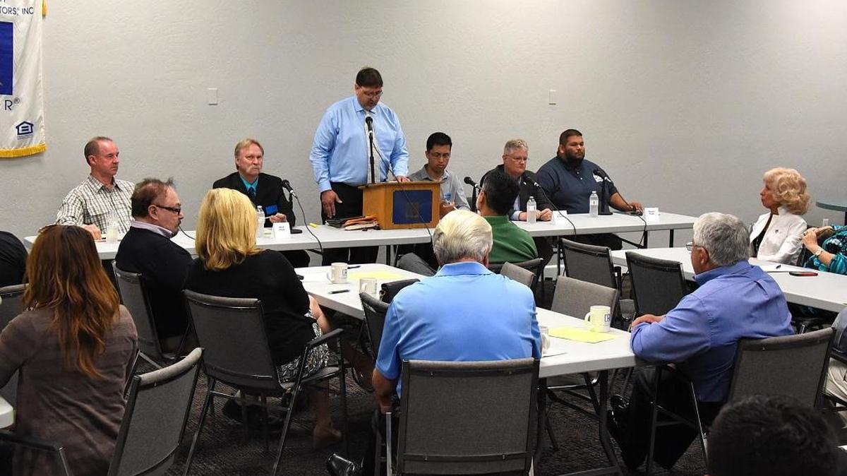 Andy Krotik, center, reads a question aloud at a forum for candidates for the District 4 supervisor seat that was hosted by the Merced County Association of Realtors on Tuesday, April 19, 2016.