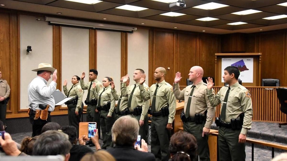 Merced County Sheriff Vern Warnke leads eight new correctional officers as they are sworn in Monday, Nov. 23, 2015.