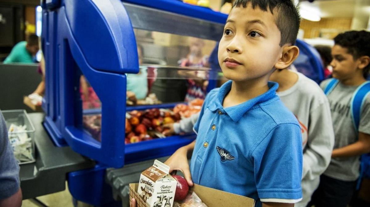 Ven Uy, 9, a student at John C. Fremont Charter School, walks with his lunch during the Merced City School District's Summer Meals Program at Peterson Elementary School in Merced, Calif., Thursday, July 7, 2016. The program provides breakfast at three sites and lunch at nine sites for children 18-years-old or younger.