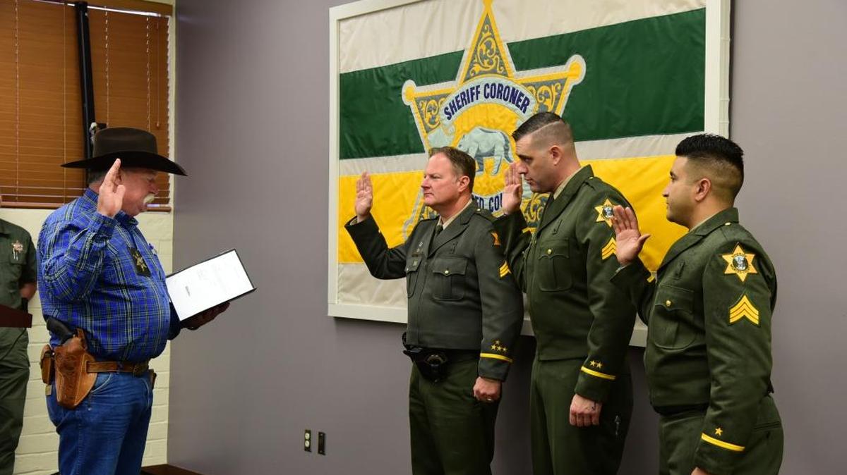 Merced County Sheriff Vern Warnke administers the oath to three new sergeants, (from left) Mark Taylor, Clint Landrum, and Steve Bassi, during a ceremony on Wednesday, May 31, 2017.