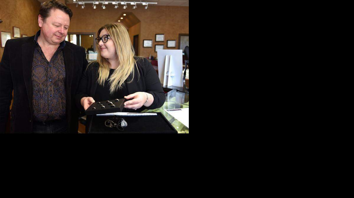 
Ron Yates and his daughter Ashton Yates-Woolley of Yates & Co Jewelers are pictured on Tuesday morning (03-03-15) with bands they give to baristas that work at Starbucks. They have given out about 100 bands since hearing about a Starbucks dress code that prohibits baristas from wearing rings with stones.

