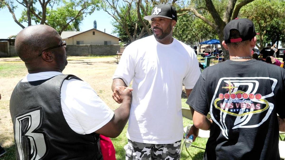 Ruff Ryders member Drew Matthews, 41, of Sacramento, center, greets fellow club members during the Northern California gathering of the Ruff Ryders motorcycle club on Saturday, July 23, 2016, at Yosemite Lake in Merced, Calif.