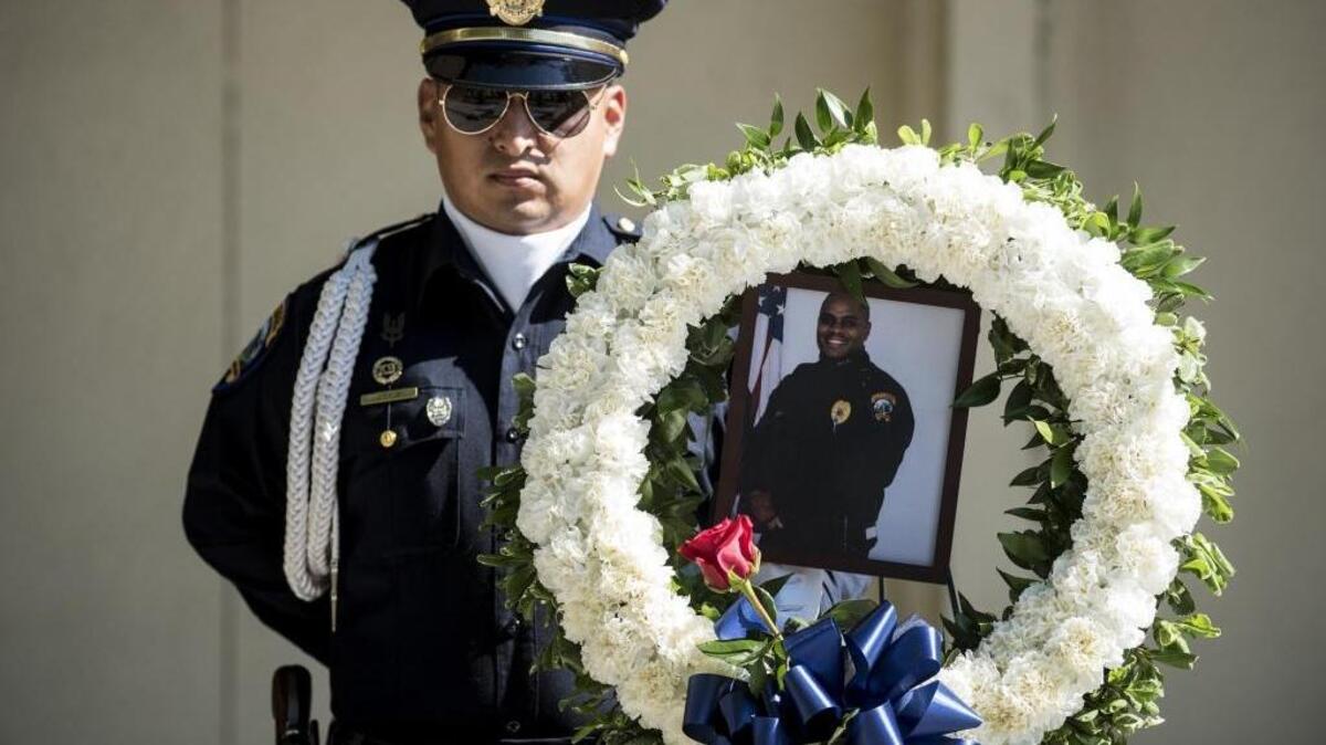 A photo of fallen Merced Police Officer Stephan Gray, is displayed in a wreath during a ceremony at the Merced Police Station in Merced, Calif., on Friday, April 14, 2017. Officer Gray, 34, was shot and killed in the line of duty on April 15, 2004 while chasing a gang member.