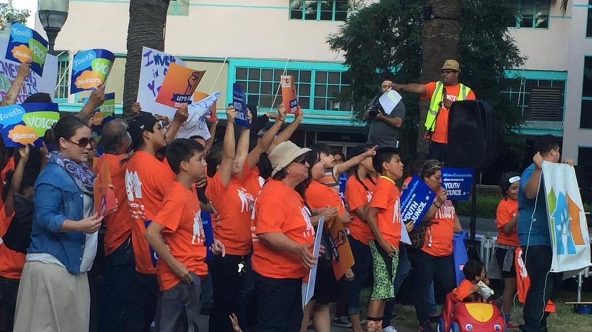 Community members chant for more funding for the Youth Council in Bob Hart Square on May 24, 2016.