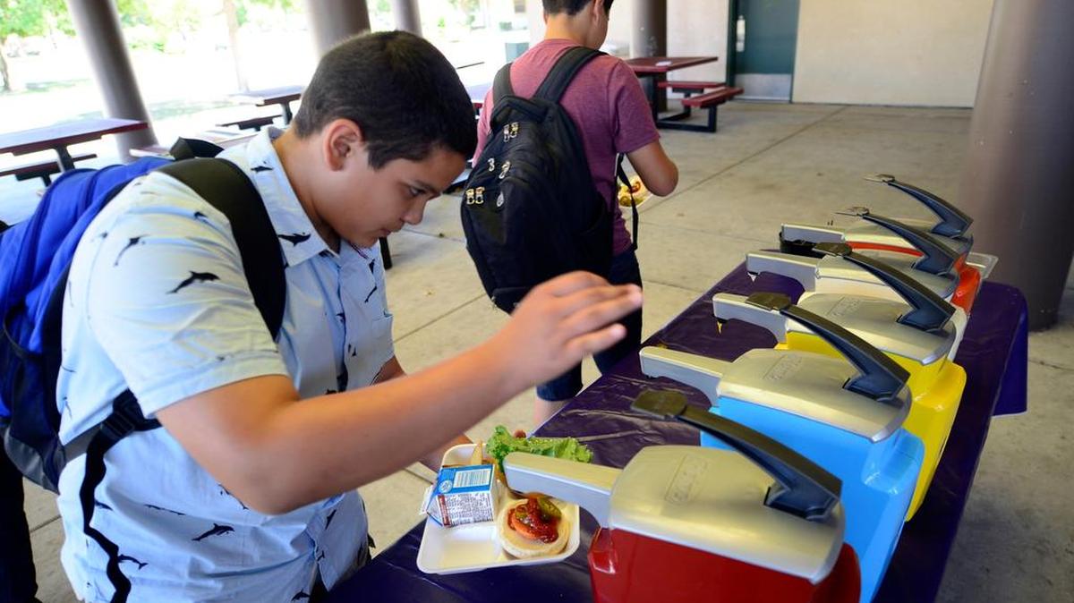 
Delhi Middle School students pick out their favorite condiments on the first day of school on Monday.
